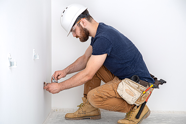 Electrician installing power socket
